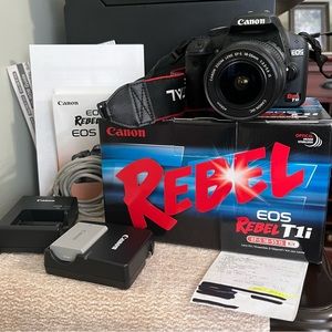 Canon EOS REBEL T1I. With EF-S 18-55 IS accessories. With carrying case.